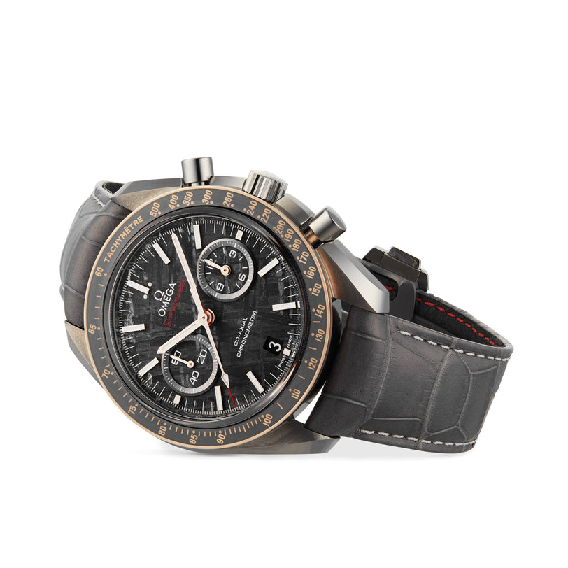 The OMEGA Speedmaster Dark Side of the Moon Meteorite features a black and gold bezel, black chronograph dial, grey alligator leather strap, and a ceramic case for added sophistication.