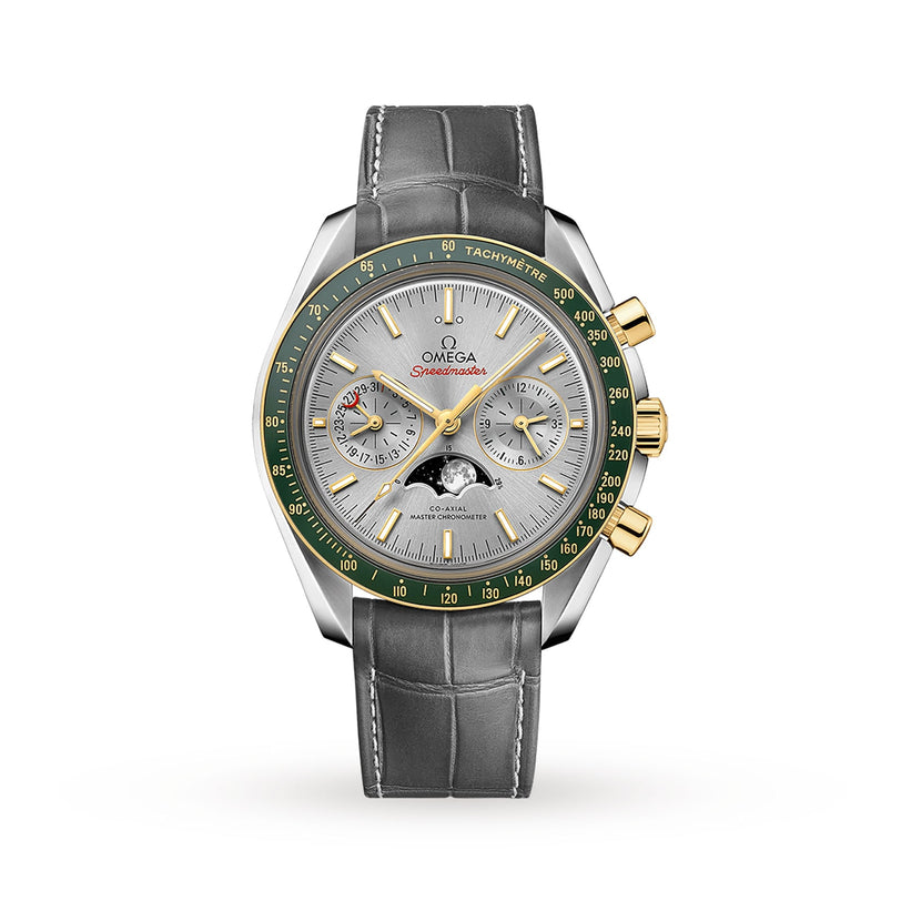 The OMEGA Speedmaster Moonphase is a luxury watch with a grey leather strap, 18K yellow gold and silver accents, a green bezel, multiple subdials, and a white dial.
