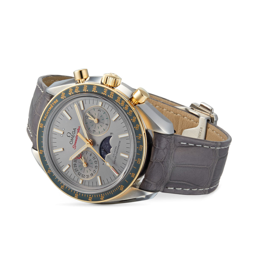 OMEGA Speedmaster Moonphase wristwatch with a grey leather strap and 18K yellow gold accents features multiple subdials, shown against a white background.