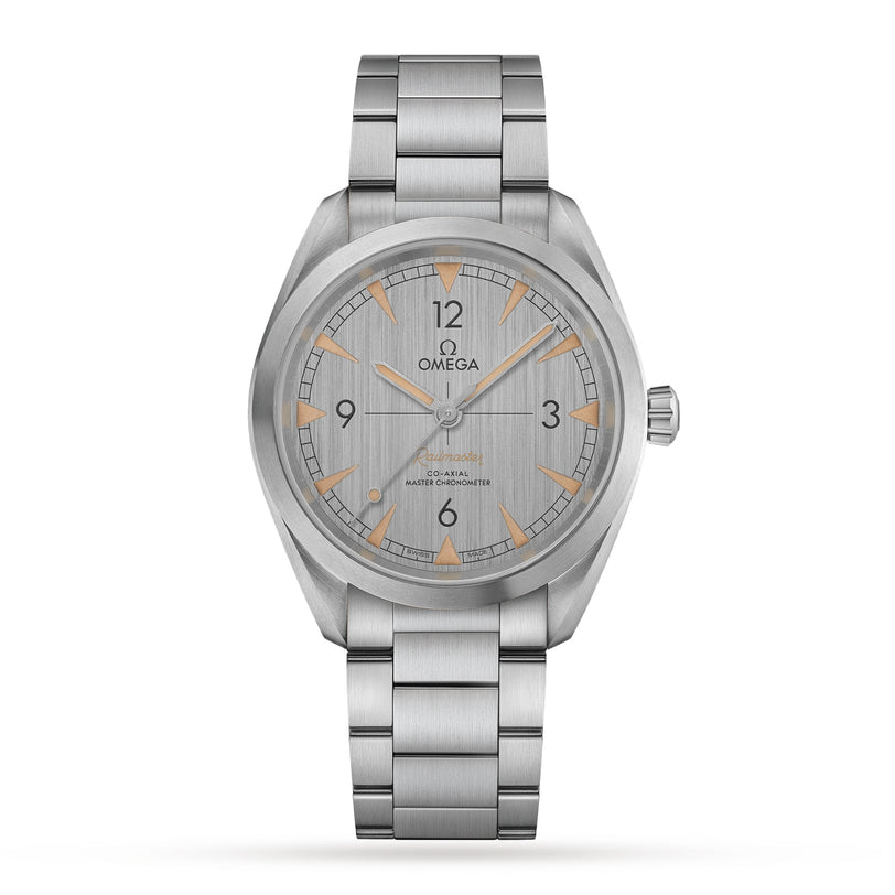 The OMEGA Seamaster Railmaster is a stainless steel wristwatch with a brushed silver dial, orange triangular hour markers, and metal bracelet. The time shows 10:10. This Co-Axial Master Chronometer blends precision with timeless design.