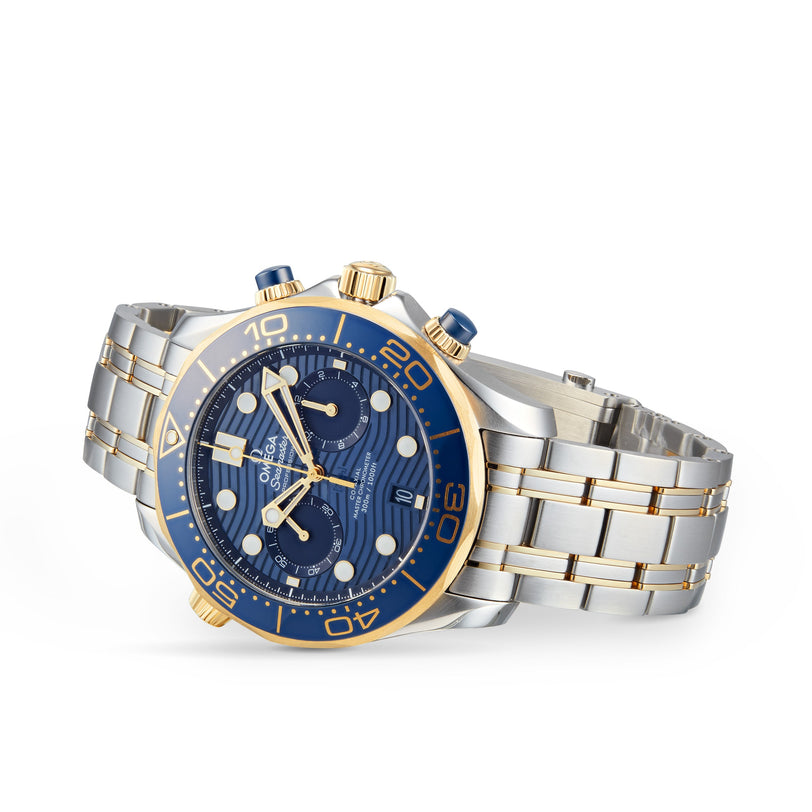 An OMEGA Seamaster Diver 300M wristwatch in stainless steel and gold with a blue dial, gold bezel, Calibre 9900 movement, and chronograph features is shown on a white background.