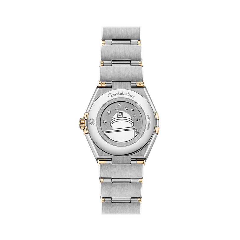 The OMEGA Constellation wristwatch, crafted in silver and 18K yellow gold, is displayed from the back with an engraved observatory and stars on the case.