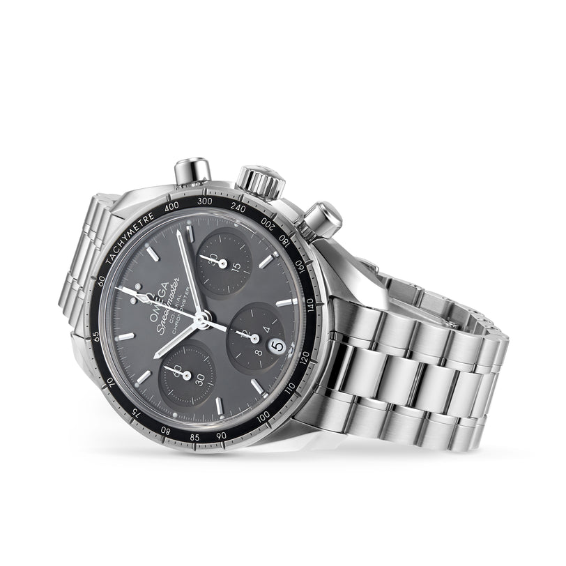 An OMEGA Speedmaster 38 chronograph wristwatch with a black dial, three subdials, and stainless steel bracelet is shown at an angle on a white background.