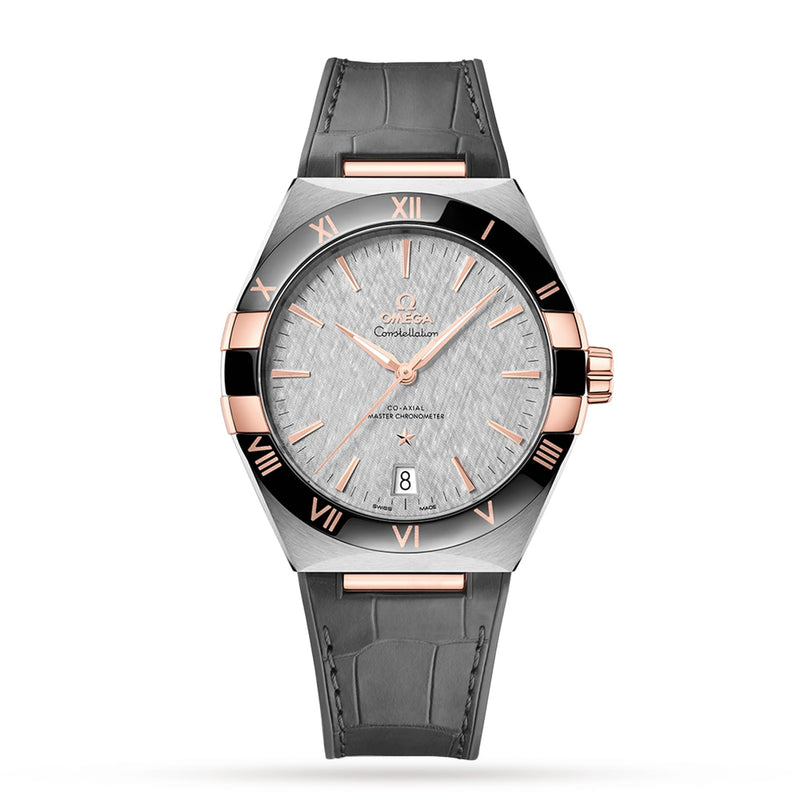 The OMEGA Constellation is a luxury wristwatch featuring a silver textured dial, rose gold accents, date at 6 o’clock, black bezel with Roman numerals, grey leather strap, and Master Chronometer-certified 8900 calibre movement.