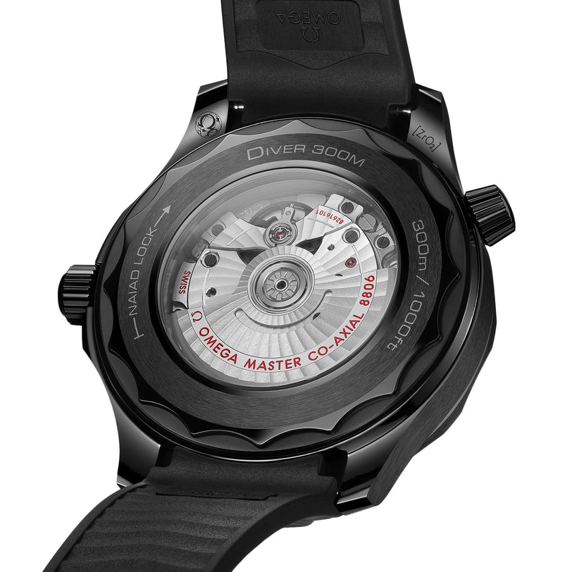Close-up of the back of the OMEGA Seamaster Diver 300M Black Black Edition, showcasing the exposed movement and engraved details through its transparent case back.