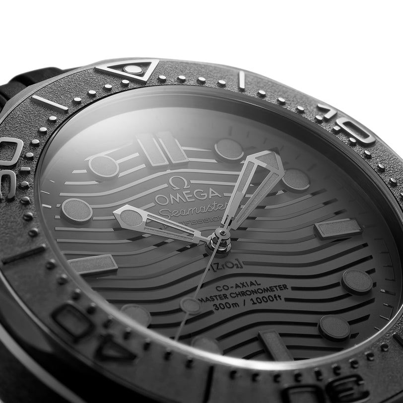 Close-up of the OMEGA Seamaster Diver 300M Black Black Edition, showcasing a wavy textured dial, bold hands, numeral markings, and “Co-Axial Master Chronometer 300m/1000ft” text, powered by the OMEGA Calibre 8800.