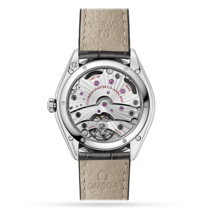 Close-up of the back of the OMEGA De Ville Trésor wristwatch, featuring an exposed Master Chronometer movement and a beige leather strap embossed with the OMEGA logo.