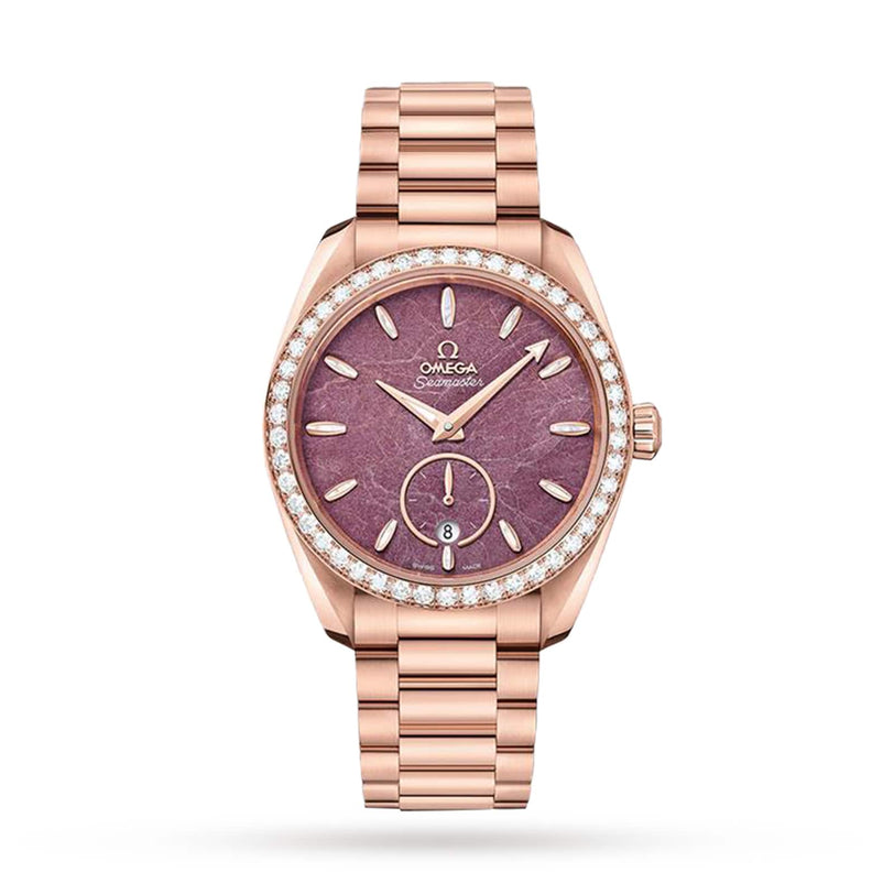 The OMEGA Seamaster Aqua Terra 150M in 18K Sedna gold features a pink textured dial, diamond bezel, date at 6 o’clock, matching bracelet, and is powered by the Co-Axial Master Chronometer calibre 8803.