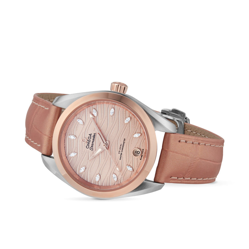 The OMEGA Seamaster Aqua Terra 150M boasts a pink leather strap, two-tone rose gold and silver case, patterned pink dial with diamond hour markers, date at 6 o’clock, and is crafted to Master Chronometer standards.