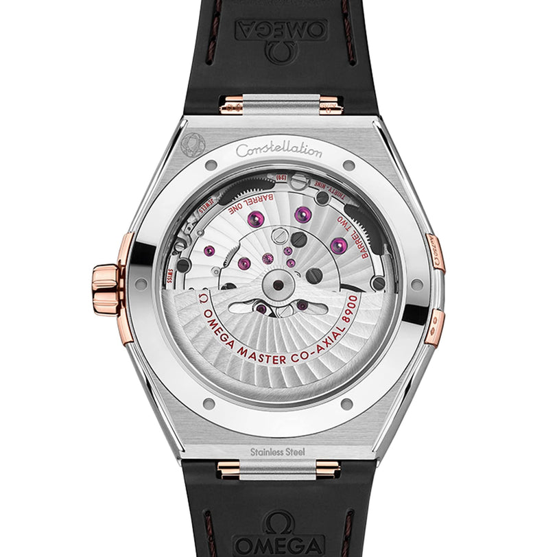 Back view of the OMEGA Constellation watch revealing the open case back, 8900 calibre movement, MASTER CO-AXIAL 8900 engraving on the rotor, and a black strap, highlighting its Constellation heritage.