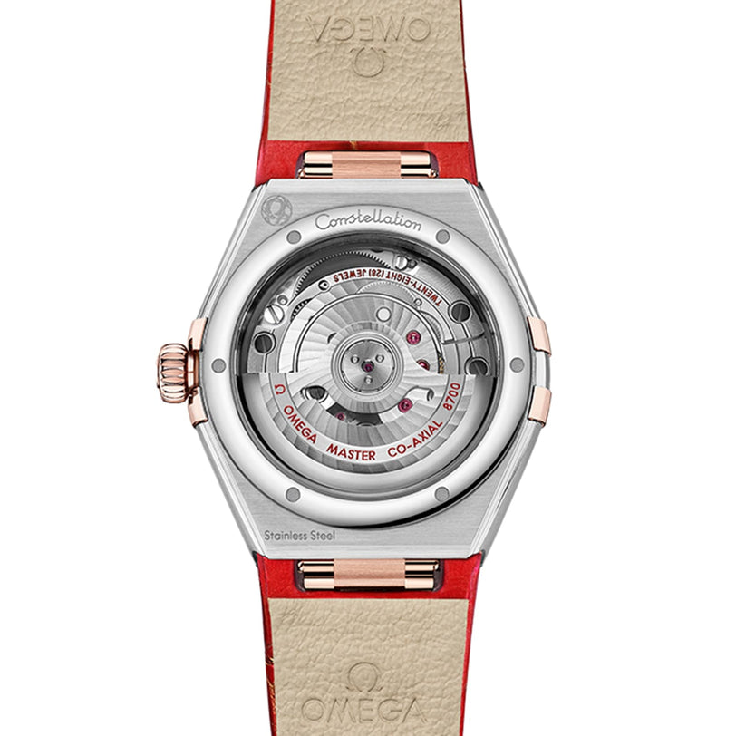 The back of the OMEGA Constellation features a transparent case, unveiling the Master Chronometer 8700 calibre, paired with a red and beige leather strap.
