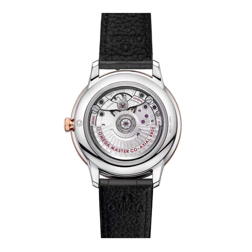 The OMEGA De Ville Prestige features a visible automatic movement labeled Master Co-Axial 8800, showcased through its caseback and complemented by a black leather strap with refined rose gold accents.