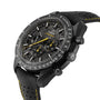 A close-up of an OMEGA Speedmaster Moonwatch Apollo 8 Dark Side Of The Moon, featuring a black dial with yellow accents, chronograph subdials, a tachymeter bezel, and a black perforated strap.