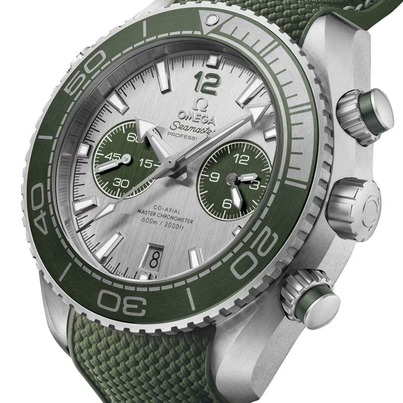 Close-up of the OMEGA Seamaster Planet Ocean 600M, featuring a green bezel and strap, two subdials on a silver dial, Co-Axial Master Chronometer movement, and a date display at 6 o’clock.