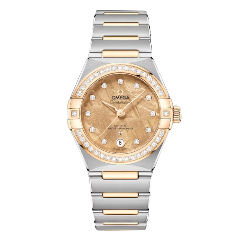 The OMEGA Constellation features a gold and silver bracelet, diamond bezel, meteorite dial, date at 6 o’clock, and is powered by the Co-Axial Master Chronometer Calibre 8700.