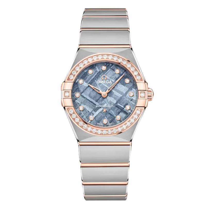 The OMEGA Constellation is a luxury wristwatch featuring a diamond-studded bezel, 18K Sedna Gold and silver-toned bracelet, and a patterned blue dial.