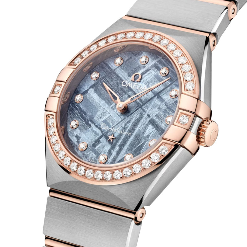 The OMEGA Constellation is a luxury wristwatch with a meteorite-pattern dial, diamond bezel, and a two-tone silver and 18K Sedna Gold bracelet.