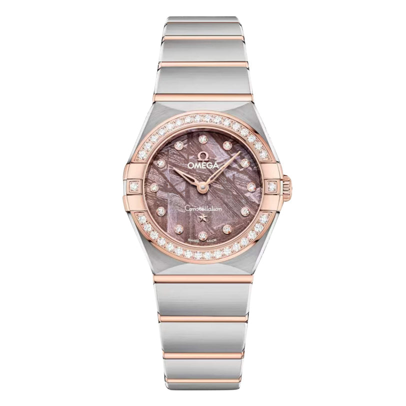 The OMEGA Constellation is a silver and rose gold wristwatch with a diamond-paved bezel, brown meteorite dial, diamond hour markers, and a metal link bracelet.