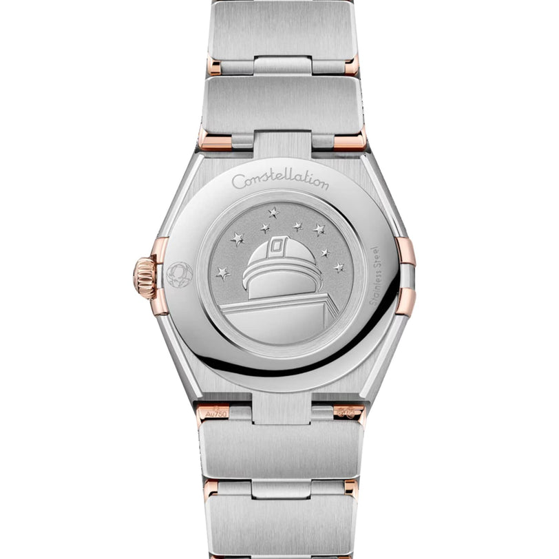 Back view of the OMEGA Constellation watch showing an engraved observatory with stars and Constellation on the case back, paired with a diamond-paved bezel.