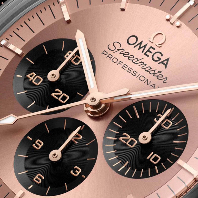 Close-up of the OMEGA Speedmaster Moonwatch Professional Sedna, showcasing rose gold hands in Sedna™ Gold and three black sub-dials for seconds, minutes, and hours.