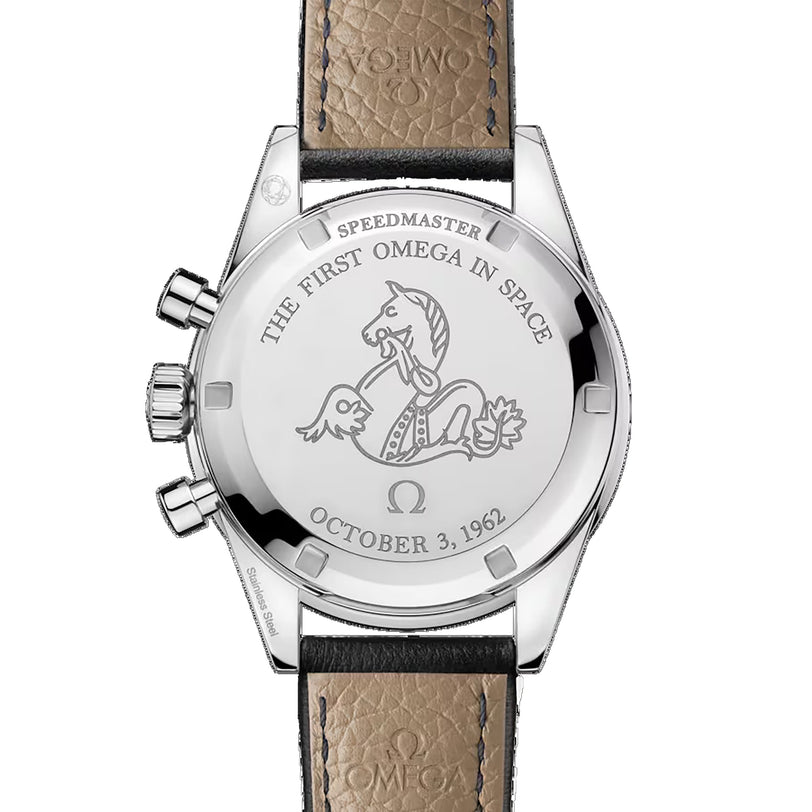 The OMEGA Speedmaster First OMEGA in Space features a caseback engraved with THE FIRST OMEGA IN SPACE, a seahorse emblem, and OCTOBER 3, 1962. A black leather strap and part of the tachymeter scale can also be seen.