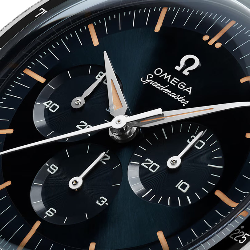 Close-up of an OMEGA Speedmaster Anniversary Series chronograph, showcasing three subdials, luminous hands and hour markers, and a bold tachymeter scale.