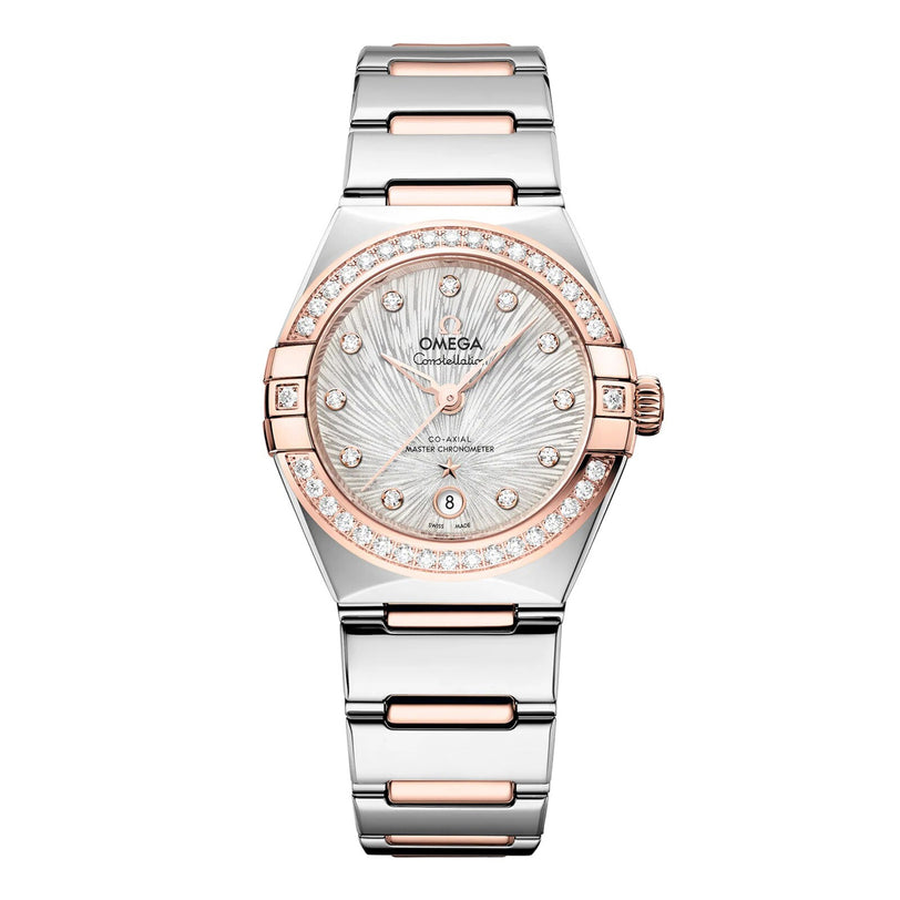 The OMEGA Constellation features a two-tone silver and rose gold band, diamond-set bezel, textured silver dial, and a date display at 6 o’clock.