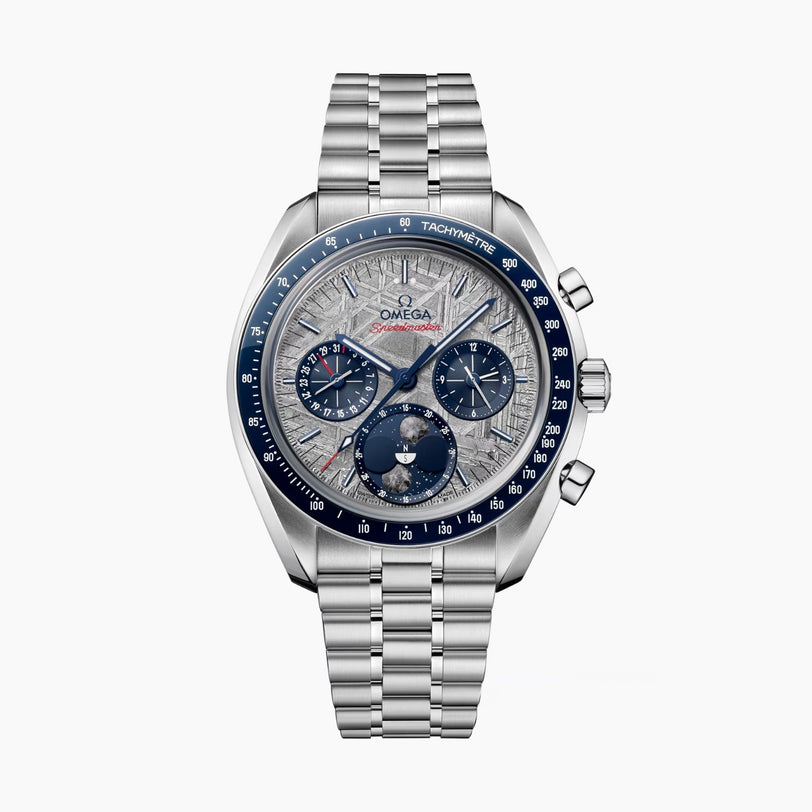 An OMEGA Speedmaster Moonphase Meteorite watch in stainless steel features a blue tachymeter bezel, silver textured dial with chronograph subdials, and a metal bracelet, displayed against a white background.