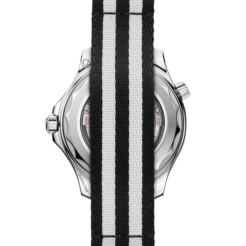 A black and white striped fabric strap covers the back of an OMEGA Seamaster Diver 300M, partially obscuring the stainless steel case and crown.