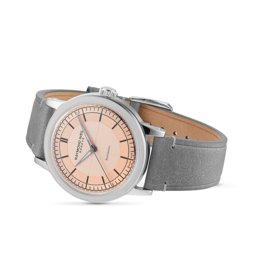 The Raymond Weil Millesime Automatic Salmon Sector Dial features a Swiss-made design with a salmon-toned dial, black hour markers, and a grey leather strap—showcasing luxury watchmaking on a white background.