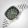 The Raymond Weil Freelancer Automatic 60 Diamonds Green Dial wristwatch features a cushion-shaped silver case, diamond-set bezel, green patterned dial with date display, metal link bracelet, Swiss-made movement, shown against a light background.