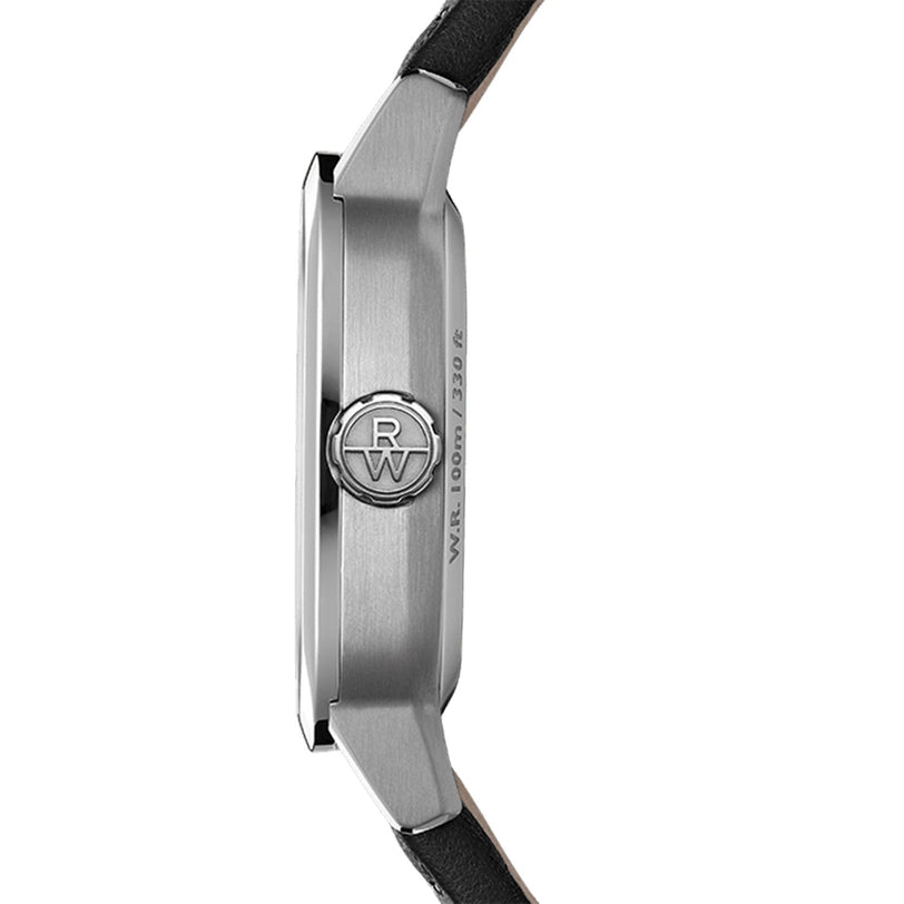 Side view of Raymond Weil Freelancer Calibre RW1212 Automatic with a cushion-shaped silver case, black leather strap, embossed crown logo, blue dial, and 1000 ft/300 m water resistance.