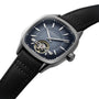 The Raymond Weil Freelancer Calibre RW1212 Automatic features a cushion-shaped case, blue dial with silver markers, visible RW1212 movement, and a black leather strap.