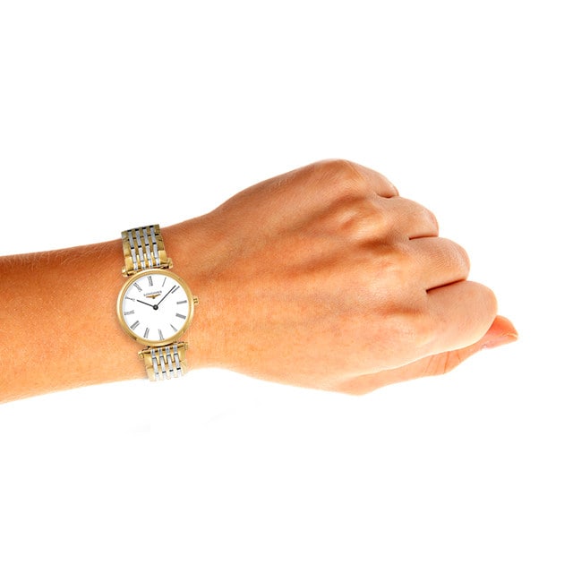 The La Grande Classique de LONGINES by Longines, featuring a metal band, is shown worn on the left wrist against a white background.
