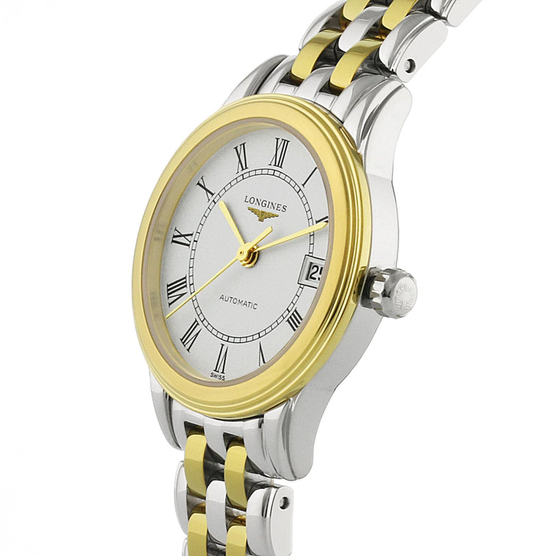 The Longines Flagship is a silver and gold wristwatch featuring Roman numerals and a date display on a white dial.