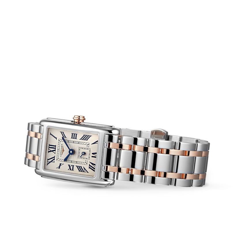 The Longines DolceVita is a rectangular wristwatch with a silver and rose gold metal link band, Roman numeral markers, date display, and quartz movement, embodying timeless elegance.