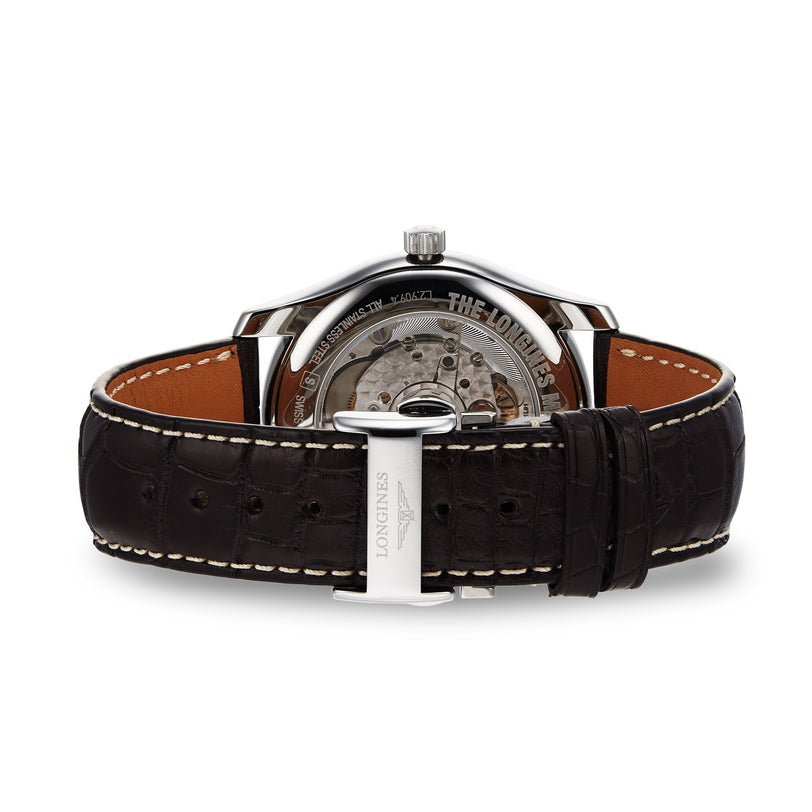 A close-up of the Longines Master Collection Moonphase shows its visible mechanical movement, brown leather strap, and metal clasp engraved with LONGINES—an elegant tribute to classic vintage timepieces.
