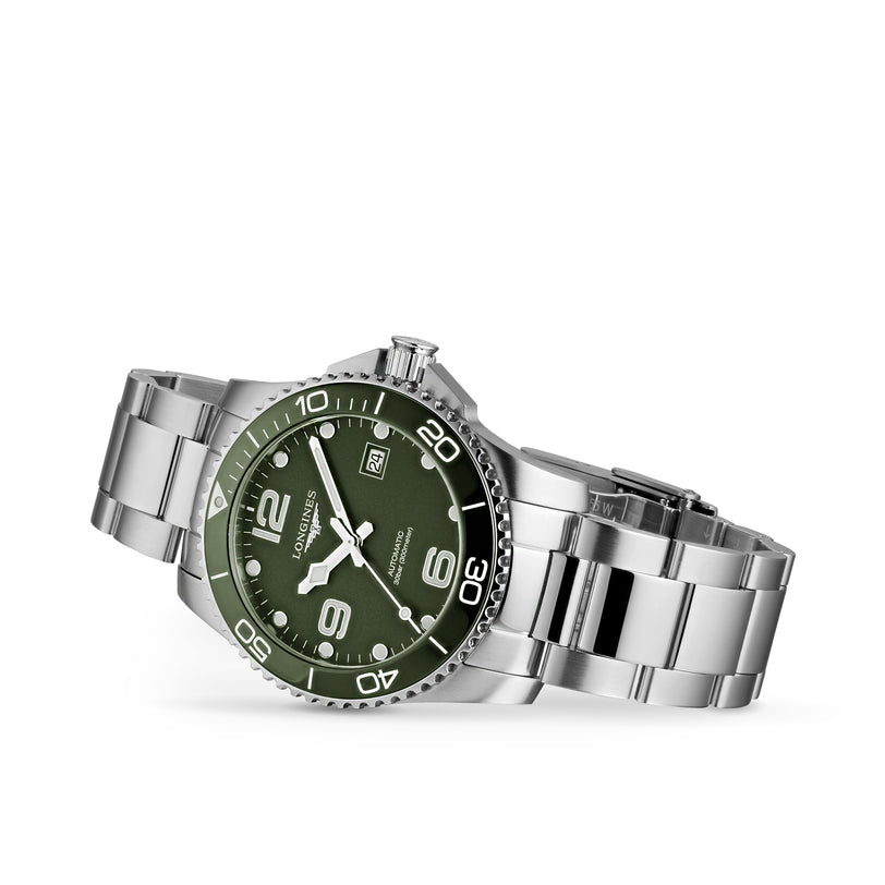 The Longines HydroConquest stainless steel diving watch features a green dial, silver hour markers, date at 3 oclock, and L888 calibre movement, displayed on a white background.
