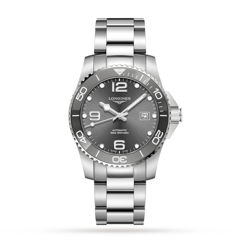 The Longines HydroConquest is a stainless steel diving watch featuring a silver bracelet, black bezel, grey dial, date window at 3 oclock, and luminous hands and markers.