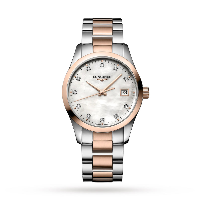The Longines Conquest Classic is a two-tone watch with a silver and rose gold band, white dial, diamond hour markers, quartz movement, and a date display at 3 o’clock.