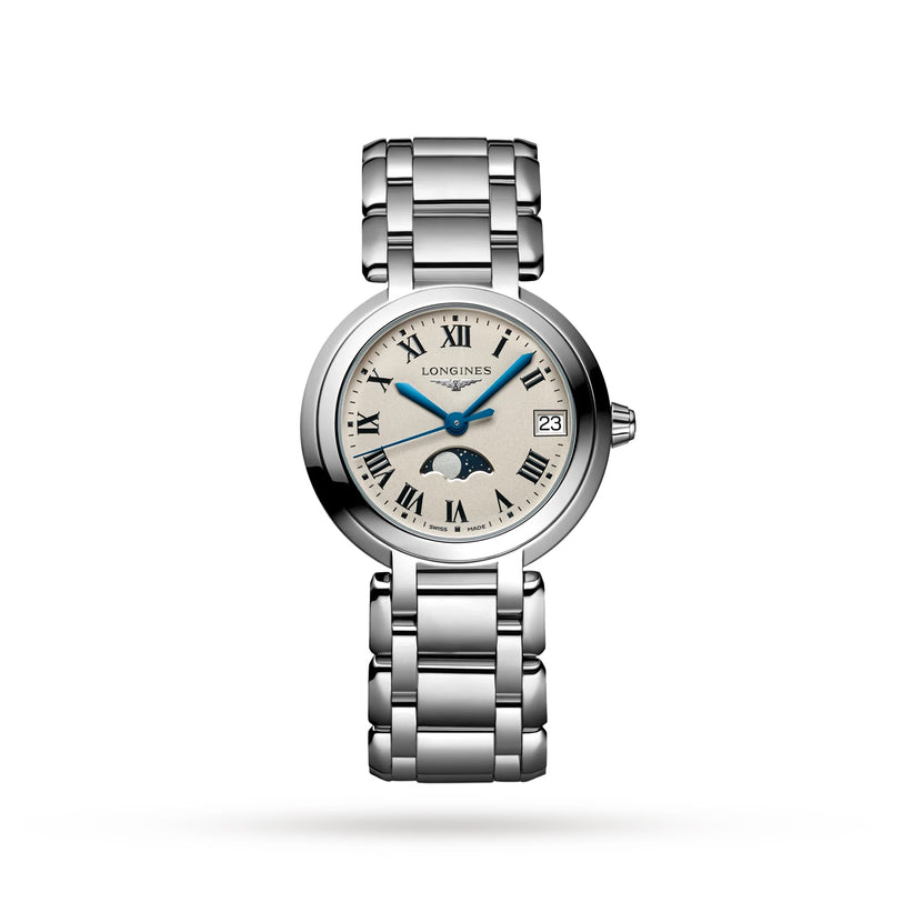 The Longines PrimaLuna Moonphase is a silver wristwatch with a round face, Roman numerals, date at 3 o’clock, moonphase display, and stainless steel case and bracelet, shown on a white background.