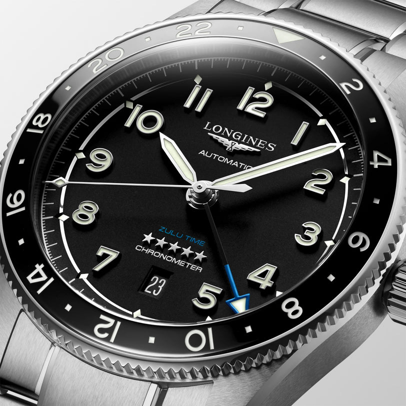 Close-up of the Longines Spirit Zulu Time, featuring a black dial, Swiss Super-LumiNova numerals and hands, date window, and a stainless steel case with matching bracelet.