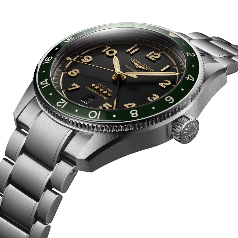 A close-up of the 42mm Longines Spirit Zulu Time, showcasing its stainless steel case, green bezel, anthracite dial with gold-tone hour markers, and a metal bracelet.