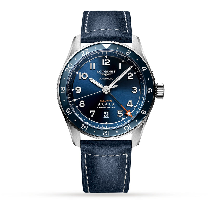 The Longines Spirit Zulu Time features a blue dial, stainless steel case, silver accents, white indices, and a blue leather strap. The automatic watch displays 10:10 and the date is set to the 25th.
