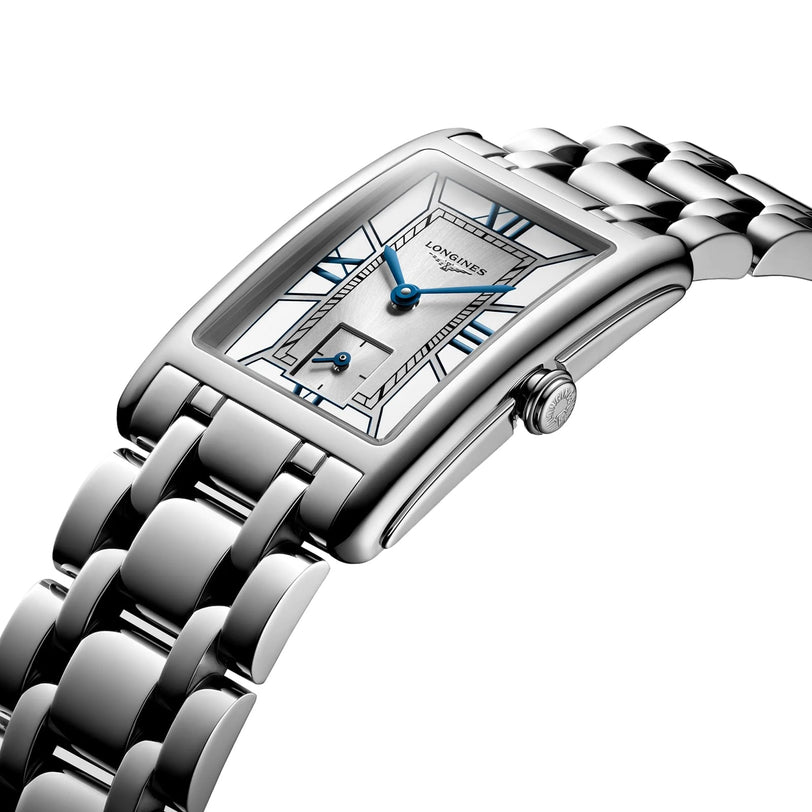 The Longines DolceVita is a silver rectangular wristwatch with blue hands, Roman numerals, and a stainless steel link bracelet.