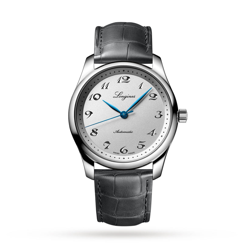 The Longines Master Collection features a silver automatic watch with a white dial, black numerals, blue hands, silicon balance-spring, and a textured dark grey leather strap, shown on a white background.