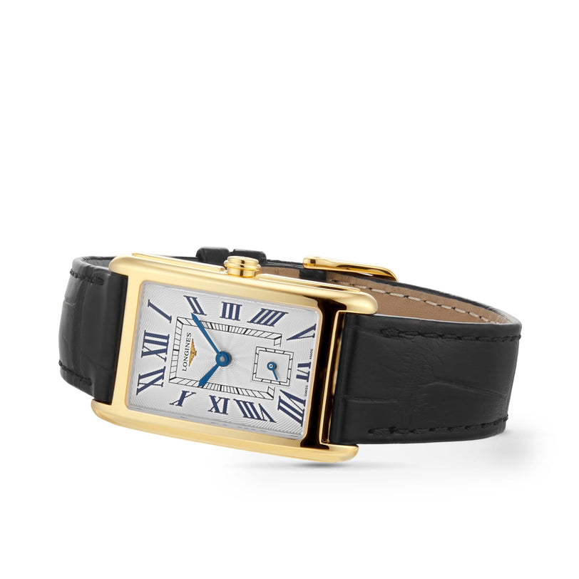 The Longines DolceVita features a rectangular 18K yellow gold case, white dial with Roman numerals, blue hands, date window, and a black leather strap for timeless elegance.