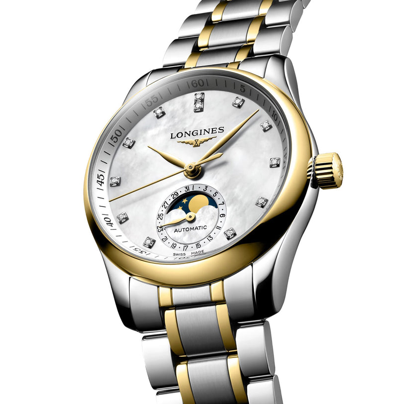 The Longines Master Collection Moonphase is a silver and gold wristwatch featuring a white dial, diamond hour markers, and a striking moonphase display above 6 o’clock.