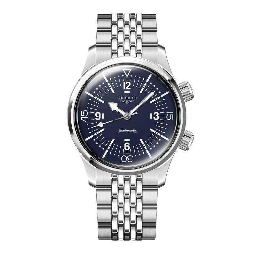 The Longines Legend Diver is a stainless steel wristwatch with a blue dial, silver hour markers, two crowns, metal link bracelet, automatic movement, and the Longines brand name.