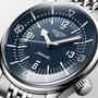 Close-up of the Longines Legend Diver watch, showcasing its black dial, luminous markers and hands, silver bezel, stainless steel bracelet, and automatic movement.